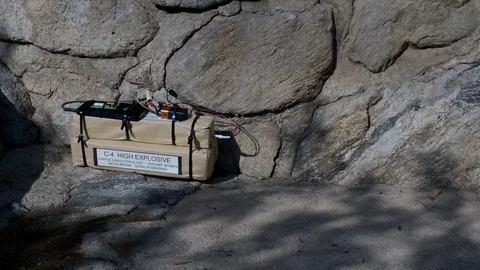 IMPROVISED EXPLOSIVE DEVICE AT STONE WALL, IN 4K SLIDER SHOT Stock Footage 99010380