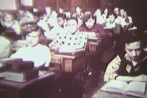 Inattentive student busy while teacher taking attendance of the class - 1954 Stock Footage 112161657