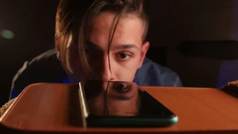 Inattentive upset guy taking the smartphone from a table. Young man trying to Stock Footage 106470878