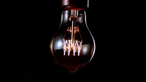 Incandescent bulb at the initial stage of ignition Stock Photos