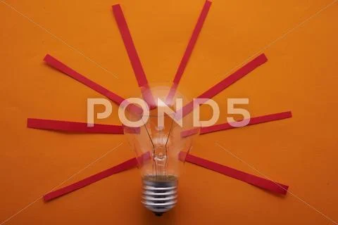 Incandescent bulbs with red rays on a yellow background Stock Photos