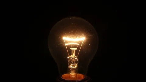 Incandescent lamp on isolated black Stock Footage 85804957