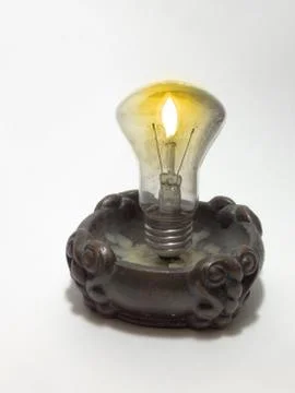 Incandescent lamp, mounted in a candlestick instead of candle Stock Photos