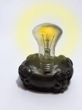 Incandescent lamp, mounted in a candlestick instead of candle Stock Photos