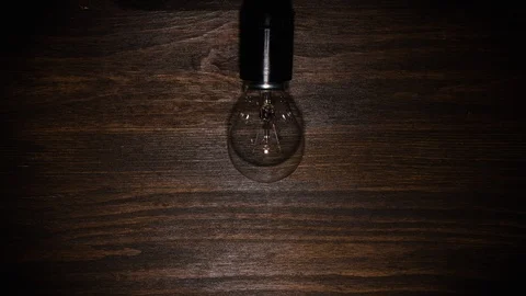 Incandescent lamp screwed into the lampholder, stop motion, animation. Stock Footage 123724608