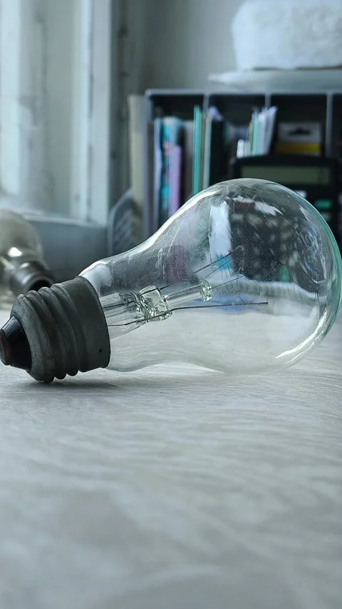 The incandescent lamp is on the table. the concept of increasing electricity Stock Footage 316286573