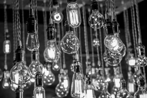 Incandescent Light bulb chandelier array hanging from the ceiling Stock Photos