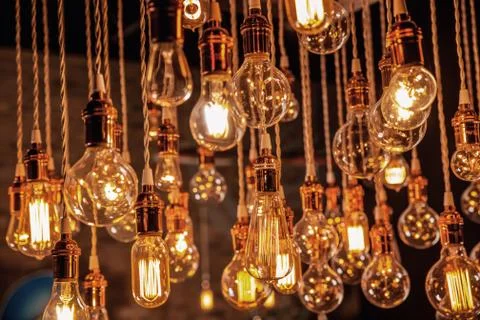 Incandescent Light bulb chandelier array hanging from the ceiling Stock Photos