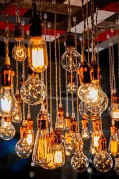 Incandescent Light bulb chandelier array hanging from the ceiling Stock Photos
