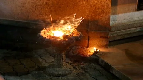 Incense and Candle flame close-up. Many Incense in a Buddhist temple. Religio Stock Footage 89684694