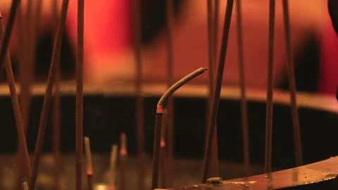 Incense Ash Falling from Smoldering Sticks in Quiet Temple Censer Stock-Footage 342528792