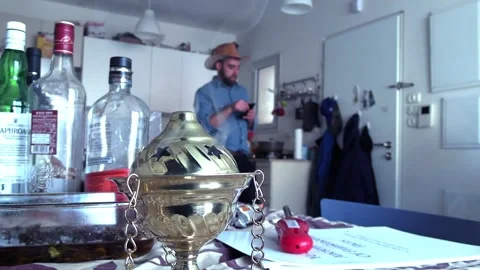 Incense burner with man in kitchen in background Video stock 235317205