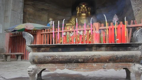 Incense Burning in Front of a Buddha Stock Footage 121194273