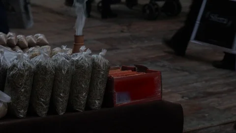 Incense burning with smoke on a small table on a pedestrian street at night. Stock Footage 122271251