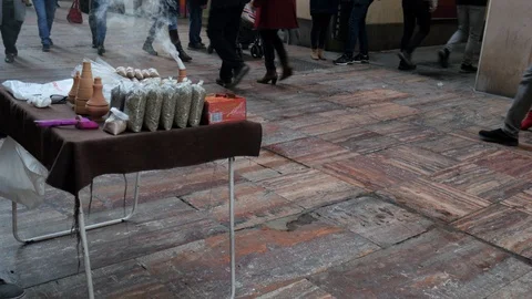 Incense burning with smoke on a small table on a pedestrian street at night. Stock Footage 122283402