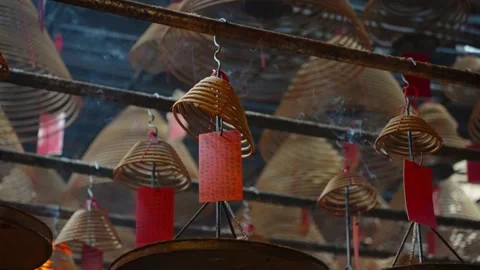 Incense coils with red prayer tags hanging in a traditional Chinese temple Stock Footage 297735367