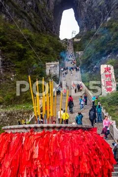 Incense pot on the bottom platform and tourists climbing 999 stairs to Haven Stock Photos