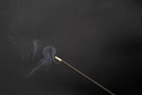 Incense smoking stick on a black background Foto stock