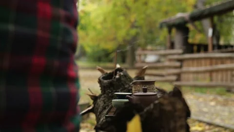 An incense stick is smoking in the background. a tea ceremony is taking place Stock Footage 220415208