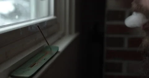 Incense wide with man with beard doing a smoke trick Stock Footage 147880739