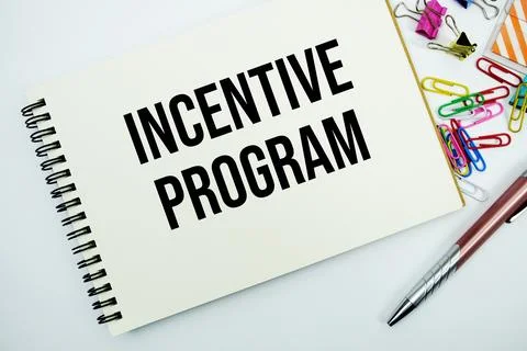Incentive program text message written on notepad with stationery flat lay .. Stock Photos