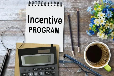 Incentive Program, Text on notebook in office desk workplace background. Photos