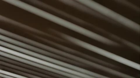 The incident light entering through the blinds moves along the wall. Time-lapse. Stock Footage 250435661