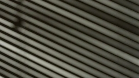 Incident light falls through the window blinds. light moves along the wall. Stock Footage 250435649