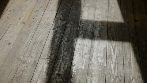 The incident light from the window moves across the wooden floor Stock Footage 146507332