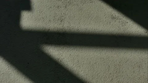 Incident light from a window moves across a concrete surface. time-lapse. Video stock 239242254