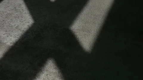 Incident light from a window moves across a concrete surface. time-lapse. Stock Footage 239419623