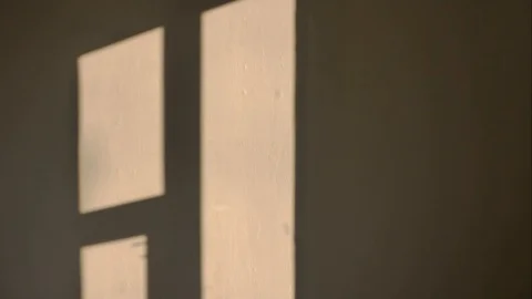 Incident light from the window moves along the wall and disappears. Stock Footage 129487490