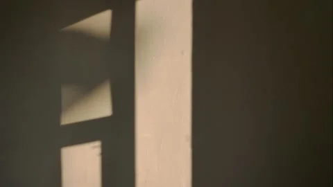 The incident light from the window moves along the wall. Video stock 146479197