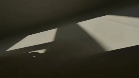 The incident light from the window moves along the wall. Shadows. Stock Footage 146838000