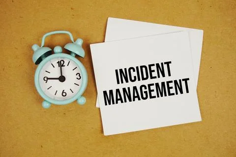 Incident Management text on sticky note with alarm clock on paper craft bac.. Stock Photos
