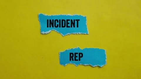 Incident report message writing on ripped torn blue paper pieces on yellow .. Stock Footage 297852205