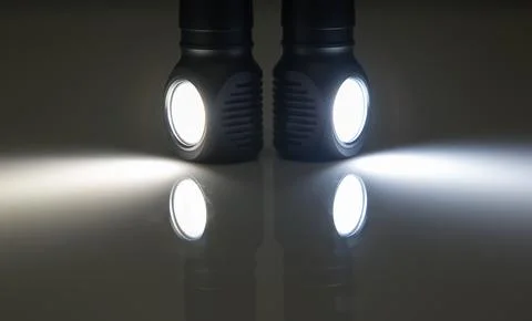 Included light beams of different flashlights on a dark background. compariso Stock Photos