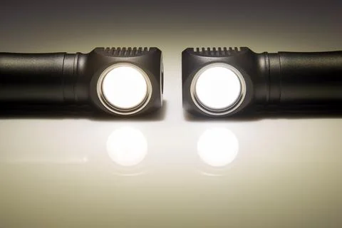 Included light beams of different flashlights on a dark background. camping a Stock Photos