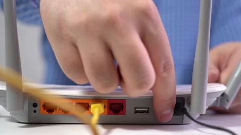 Includes Wi-Fi router. Presses the power button. Close-up Stock Footage 152473150