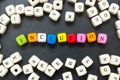 Inclusion text of multi colored cubes on dark background. Inclusive social co Stock-Fotos