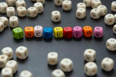 Inclusion text of multi colored cubes on dark background. Inclusive social co Stock-Fotos