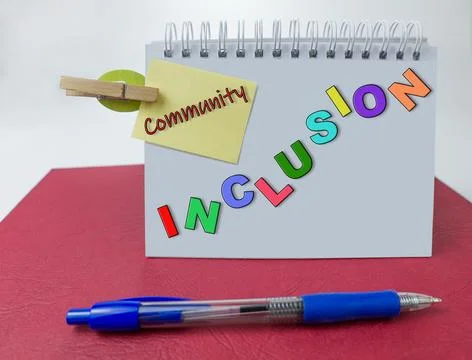 Inclusion written on a  notebook with a pen Stock Photos