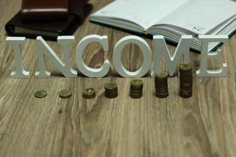 Income coin stack text letter Stockfoto's