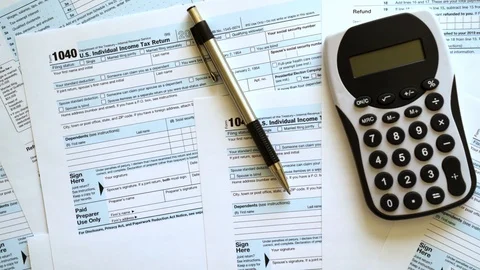 Income Tax Return Refund Forms 1040 pan shot Stock Footage 116740185