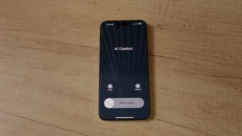 Incoming call from AI Chatbot shown on smartphone screen placed on wooden table Stock Footage 334041725