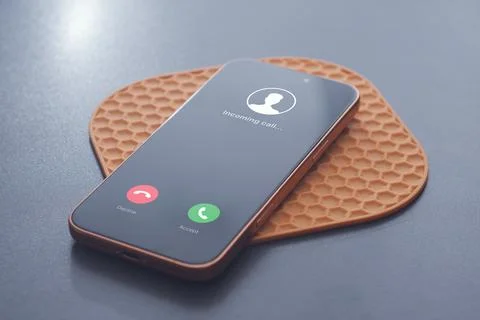 Incoming call interface displayed on modern smartphone on a table. Concept of Stock Photos