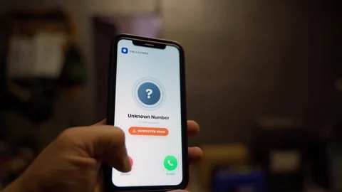 Incoming call from unknown number with spam warning on smartphone. Call blocker Stock Footage 342735662