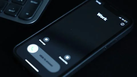 "Incoming Call from Work" – Mobile phone on a sleek black background. Video stock 305336273