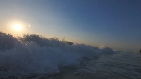 Incoming ocean wave at sunset time shot from water Stock Footage 90004972