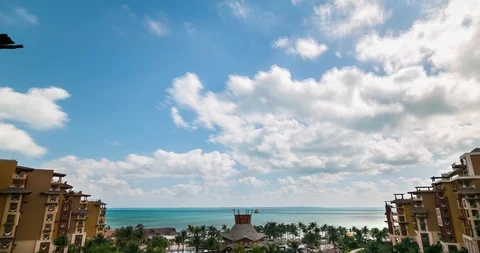 Incoming puffy white cumulus clouds as seen from a beautiful Mexican beach Stock Footage 104319700